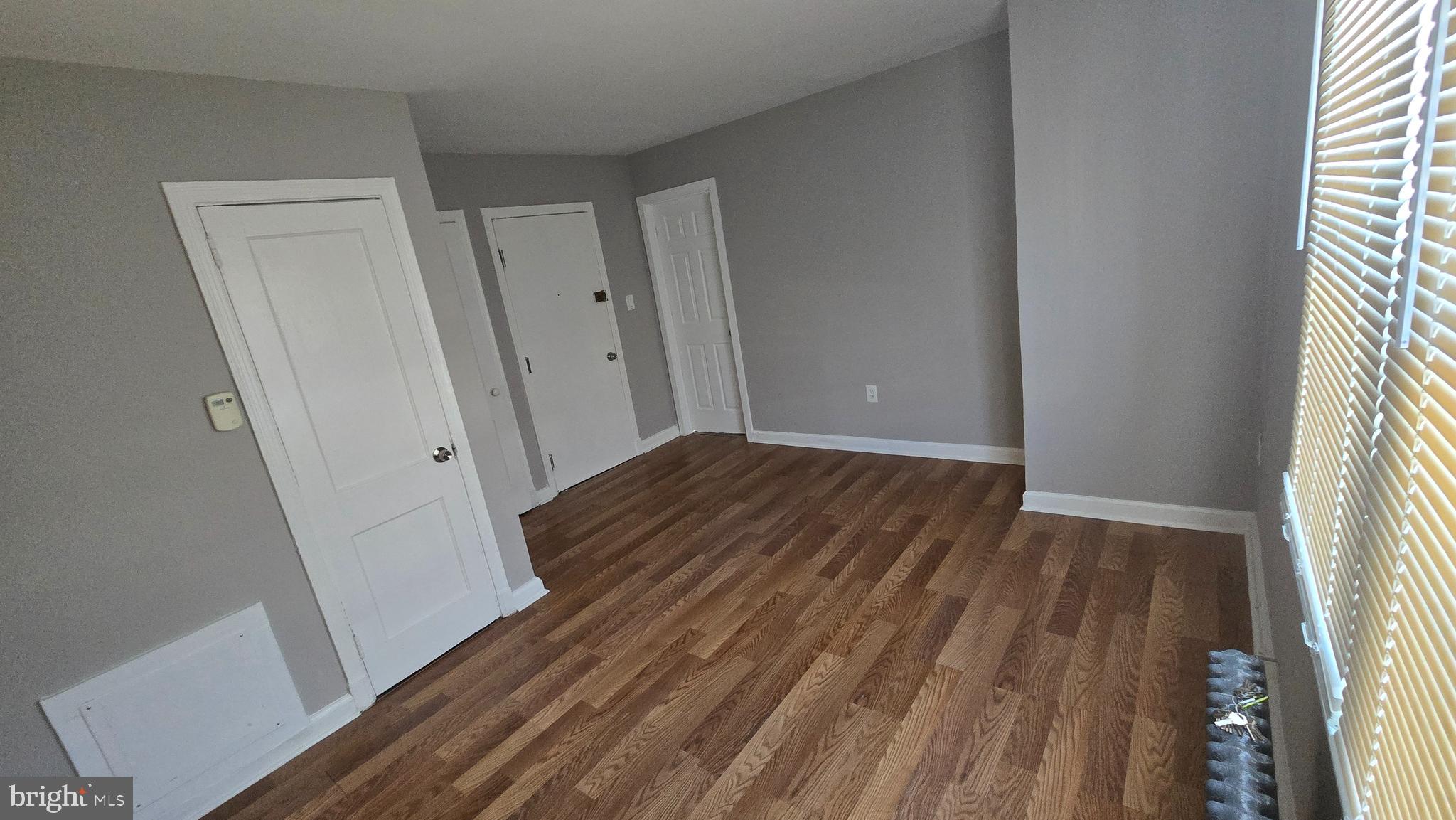 a view of a room with wooden floor and staircase