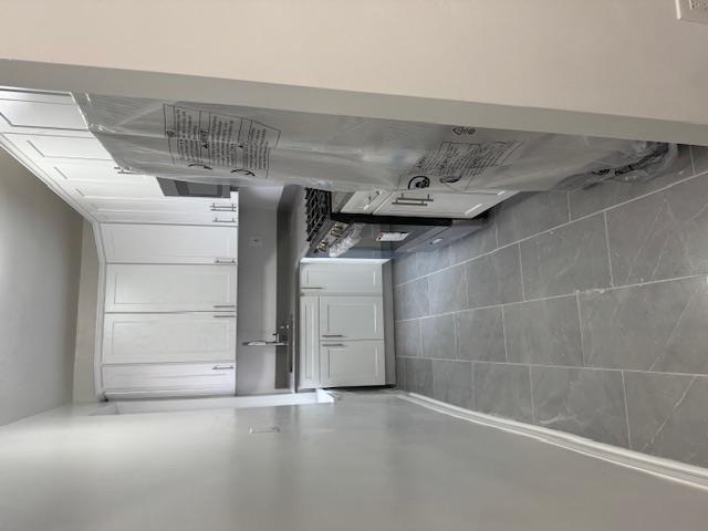 a kitchen with stainless steel appliances a sink and a refrigerator