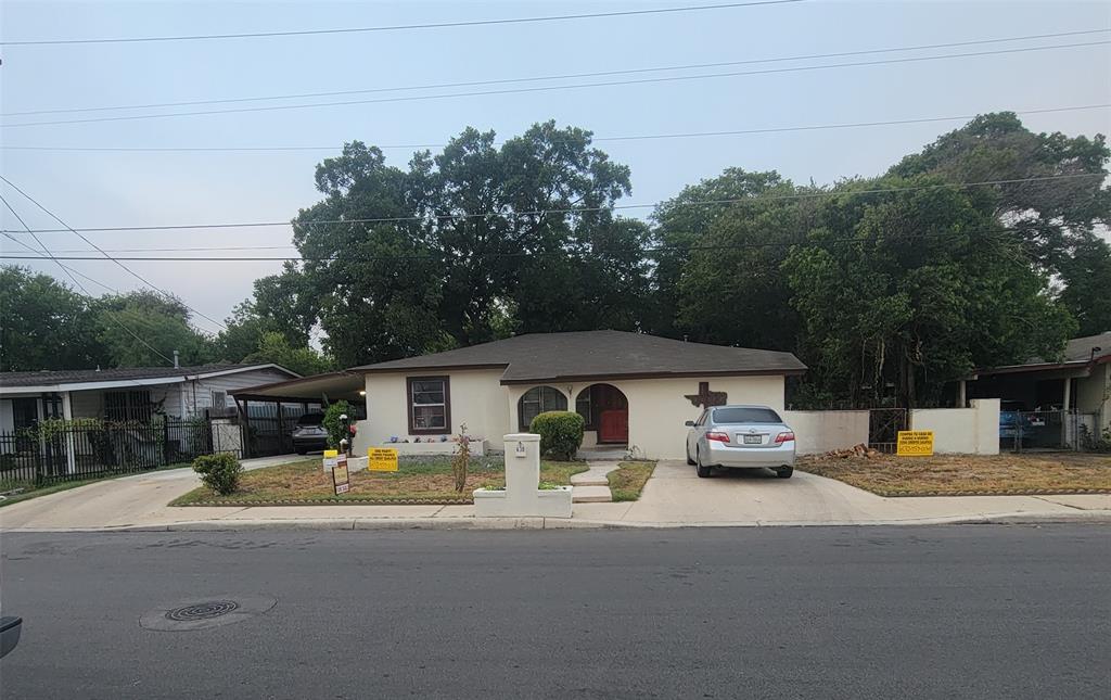 a view of the house with car parked beside it