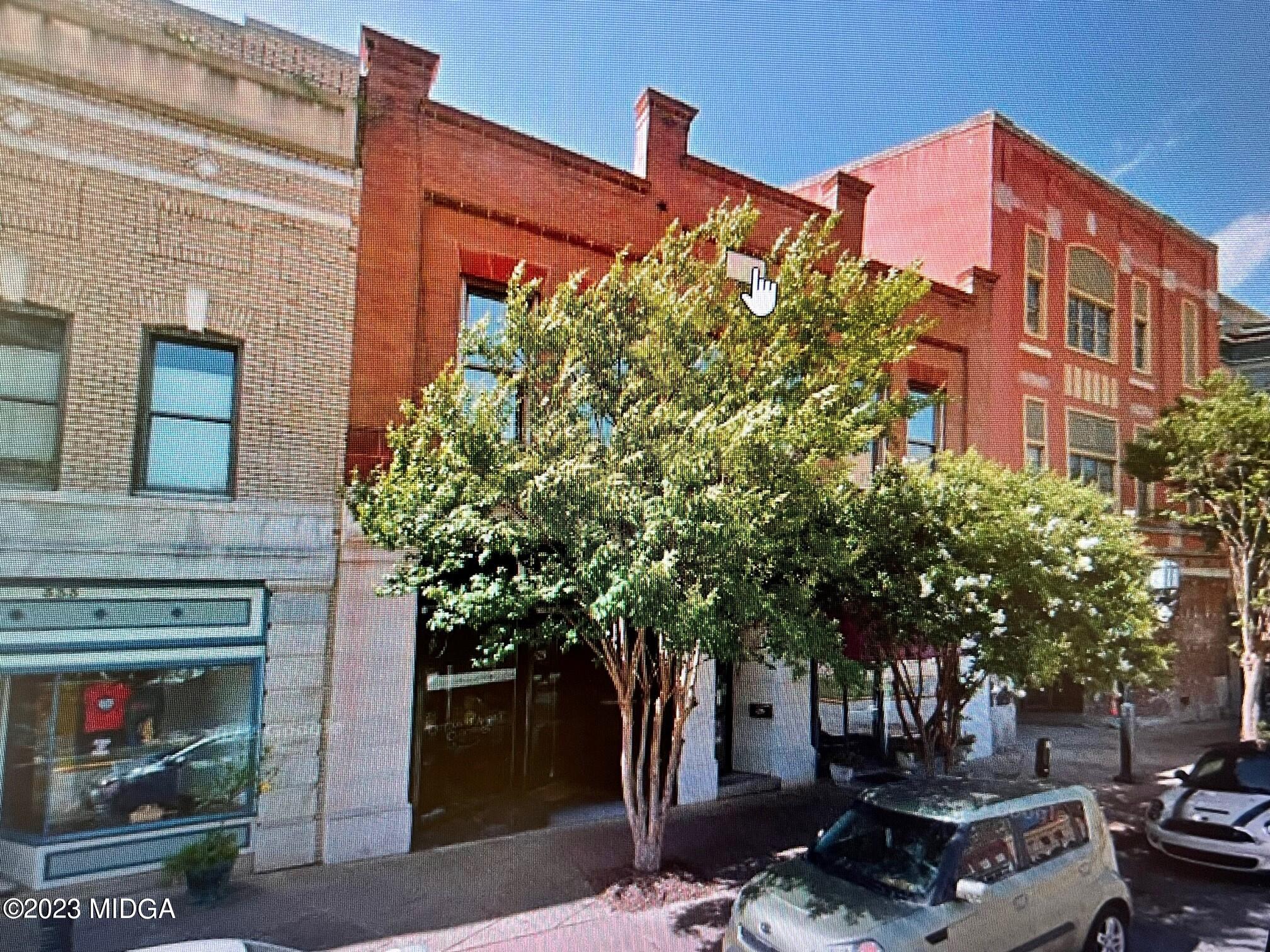 a front view of a building with plants