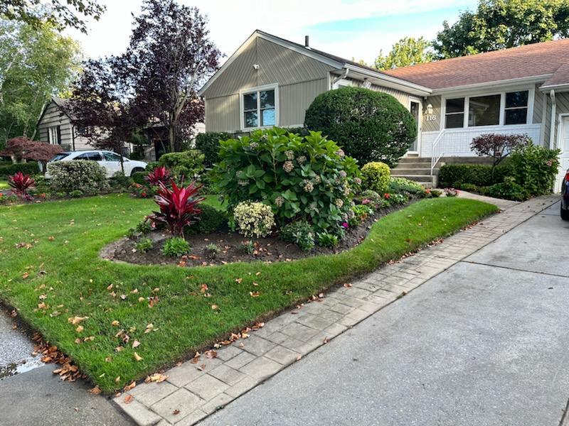 a front view of a house with a garden