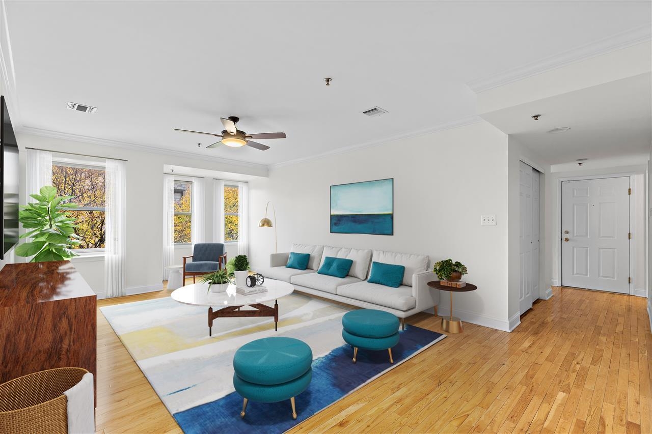 a living room with furniture potted plant and a window