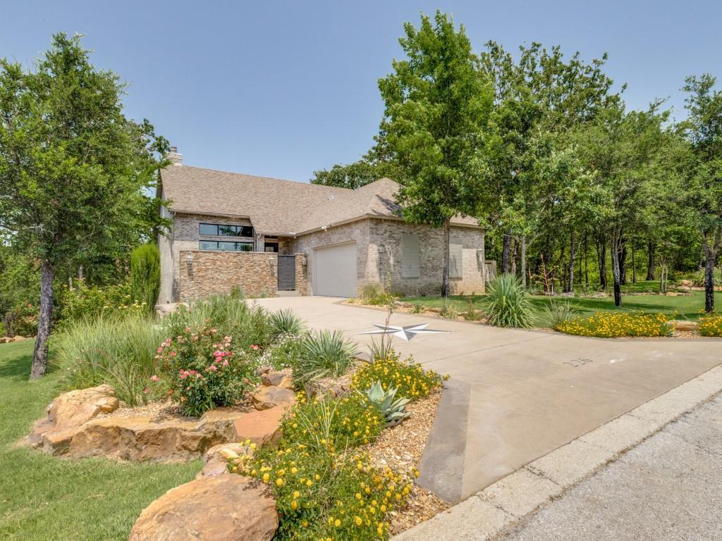 a front view of a house with a yard and a garage