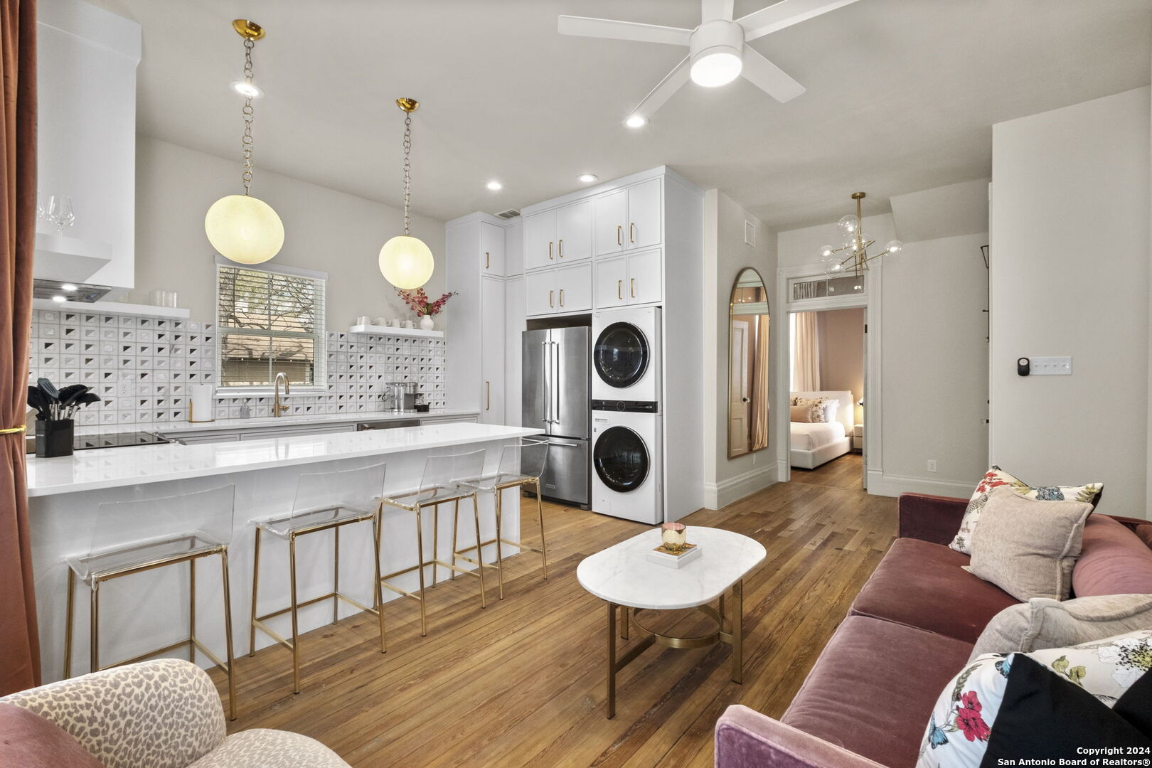 a living room with furniture a sink a dining table and chairs