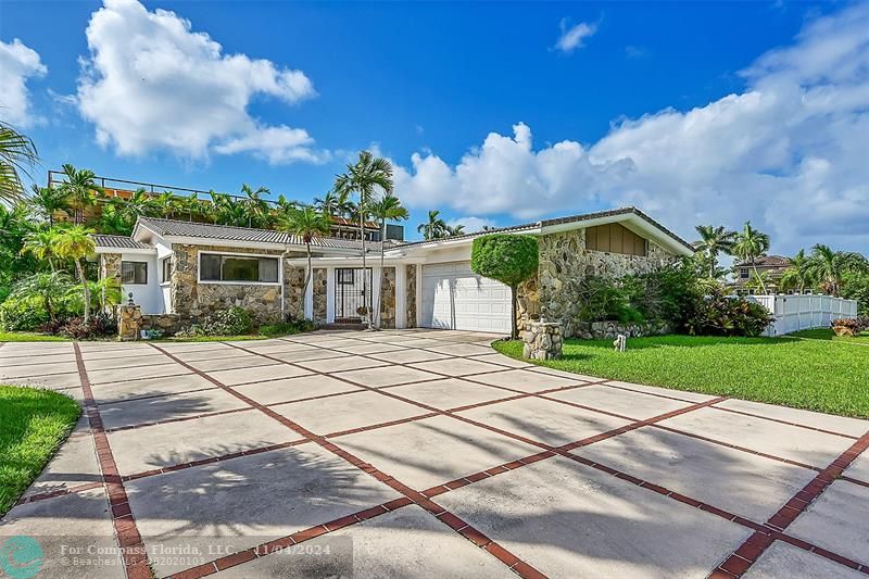 a front view of a house with a yard and a garage