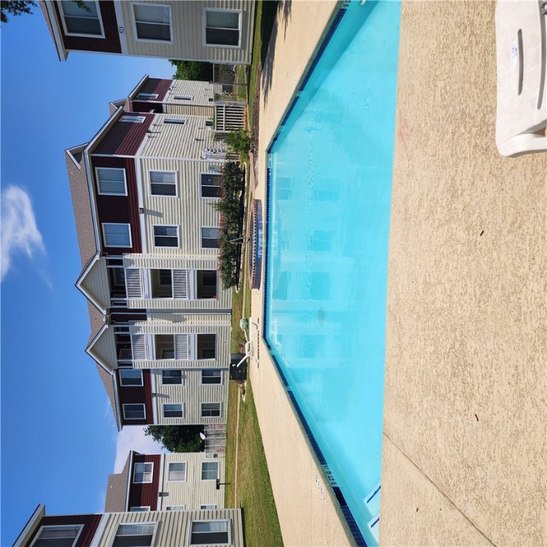 a swimming pool with outdoor seating and yard