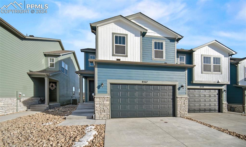 a front view of a house with a yard and garage