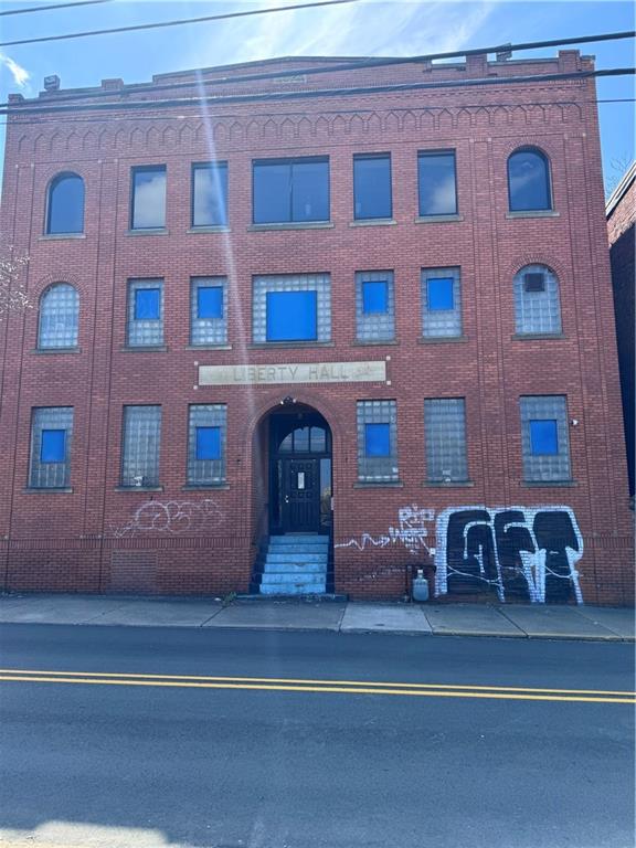 a front view of building with car parked