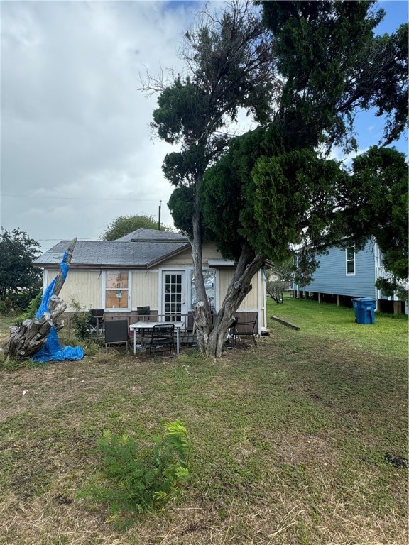 a view of a house with a yard and sitting area