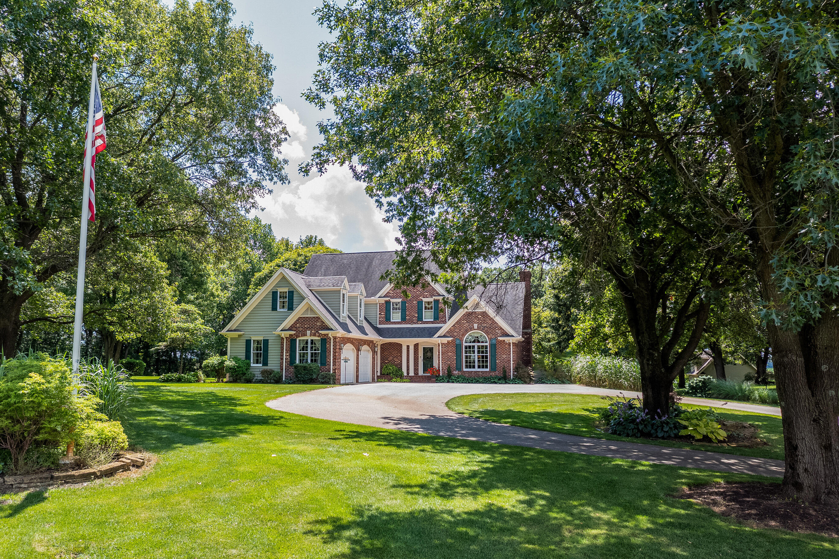 a front view of house with yard and green space