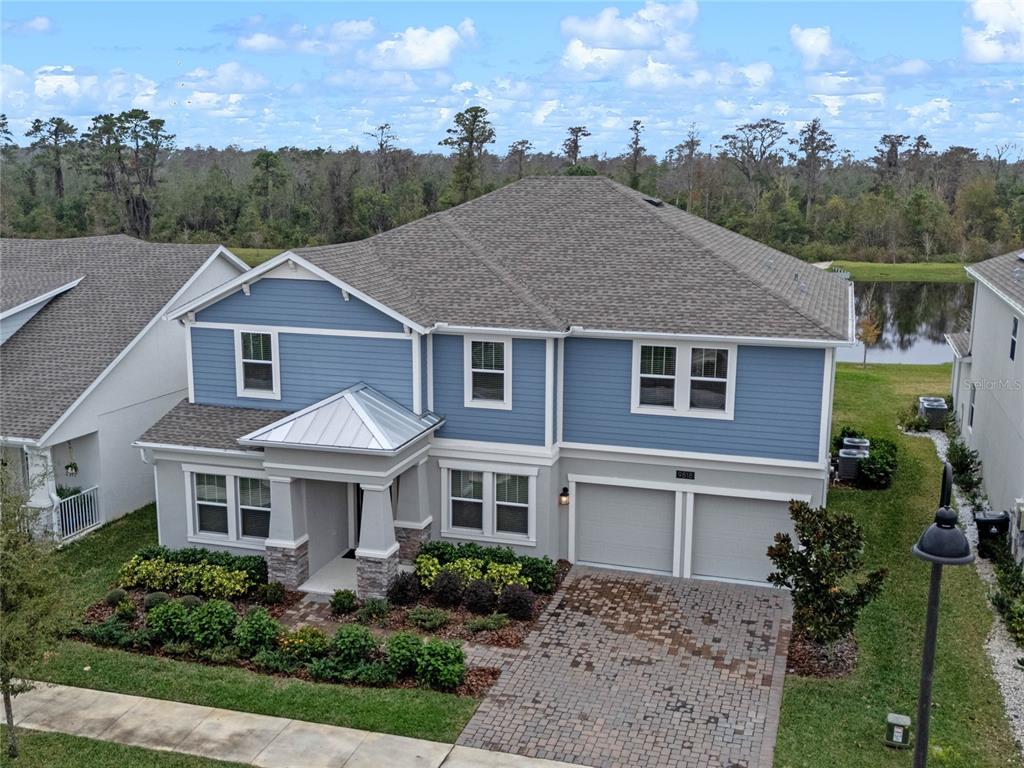 a aerial view of a house next to a yard