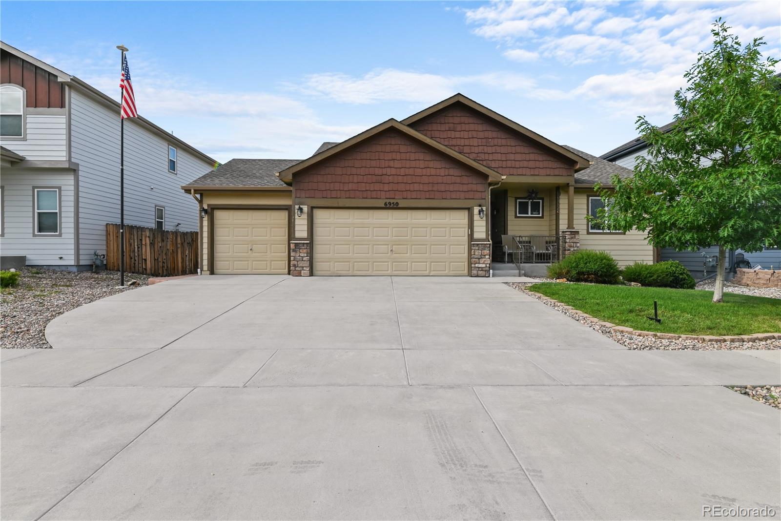 a view of house with garage and yard