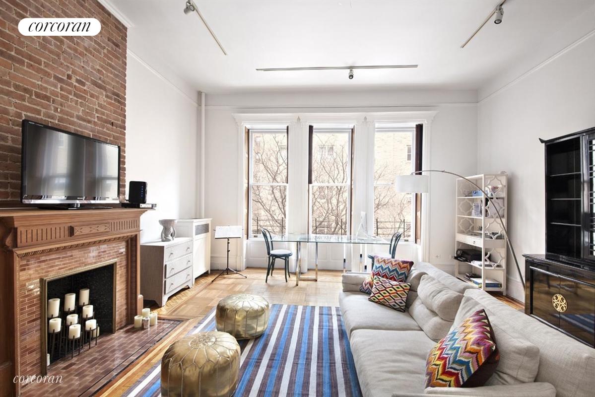 a living room with fireplace furniture and a flat screen tv