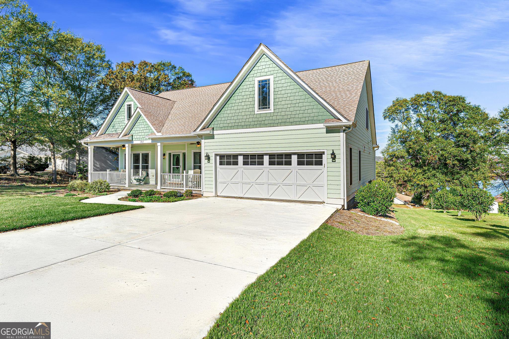 a front view of a house with a garden and plants