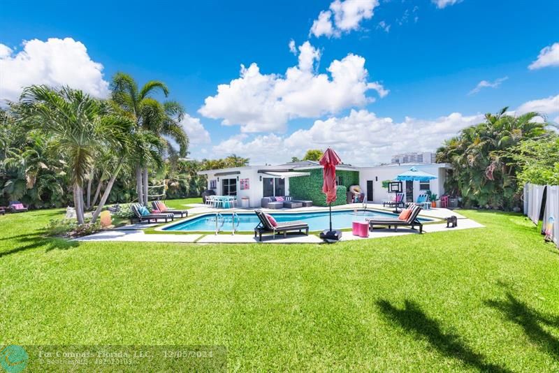 a view of a house with swimming pool and sitting area