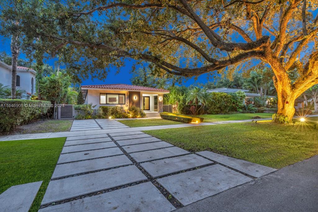 a front view of a house with a yard