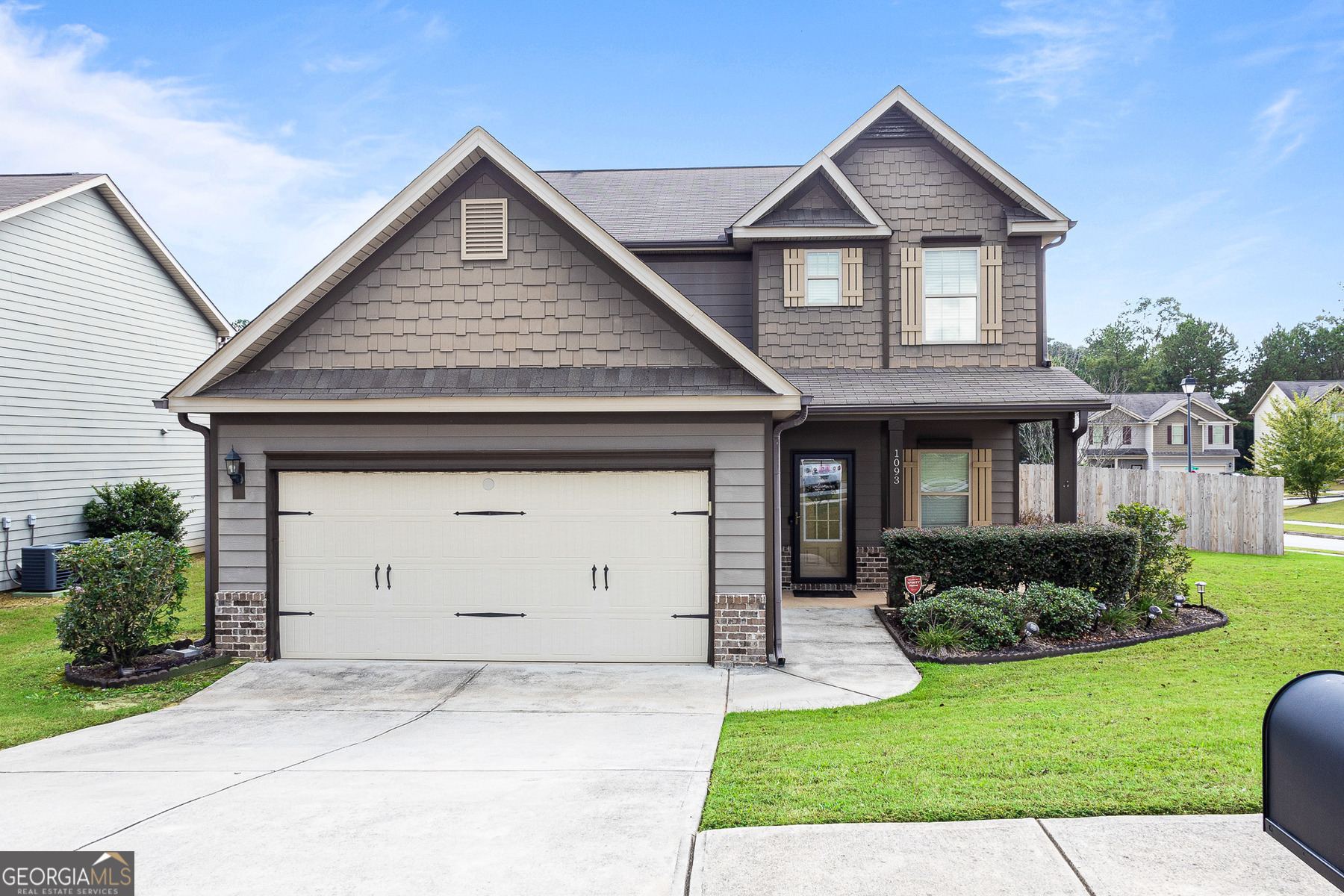 a front view of a house with a yard and garage