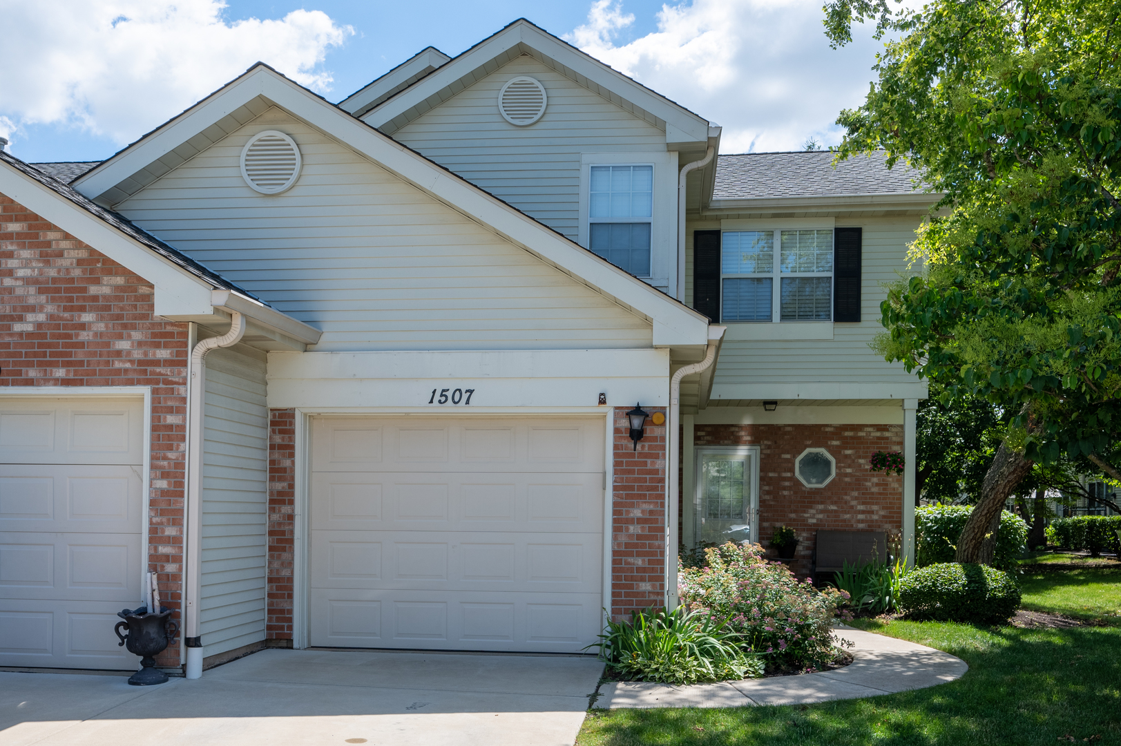 a front view of a house with a yard garage and outdoor seating