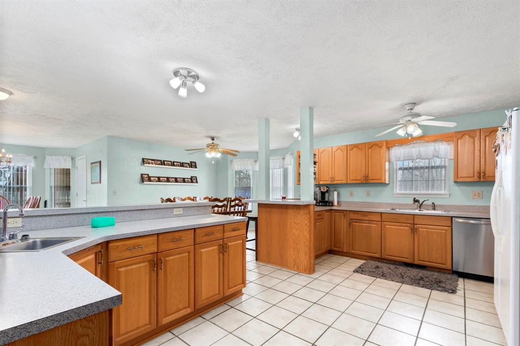 a kitchen with stainless steel appliances granite countertop a sink and cabinets