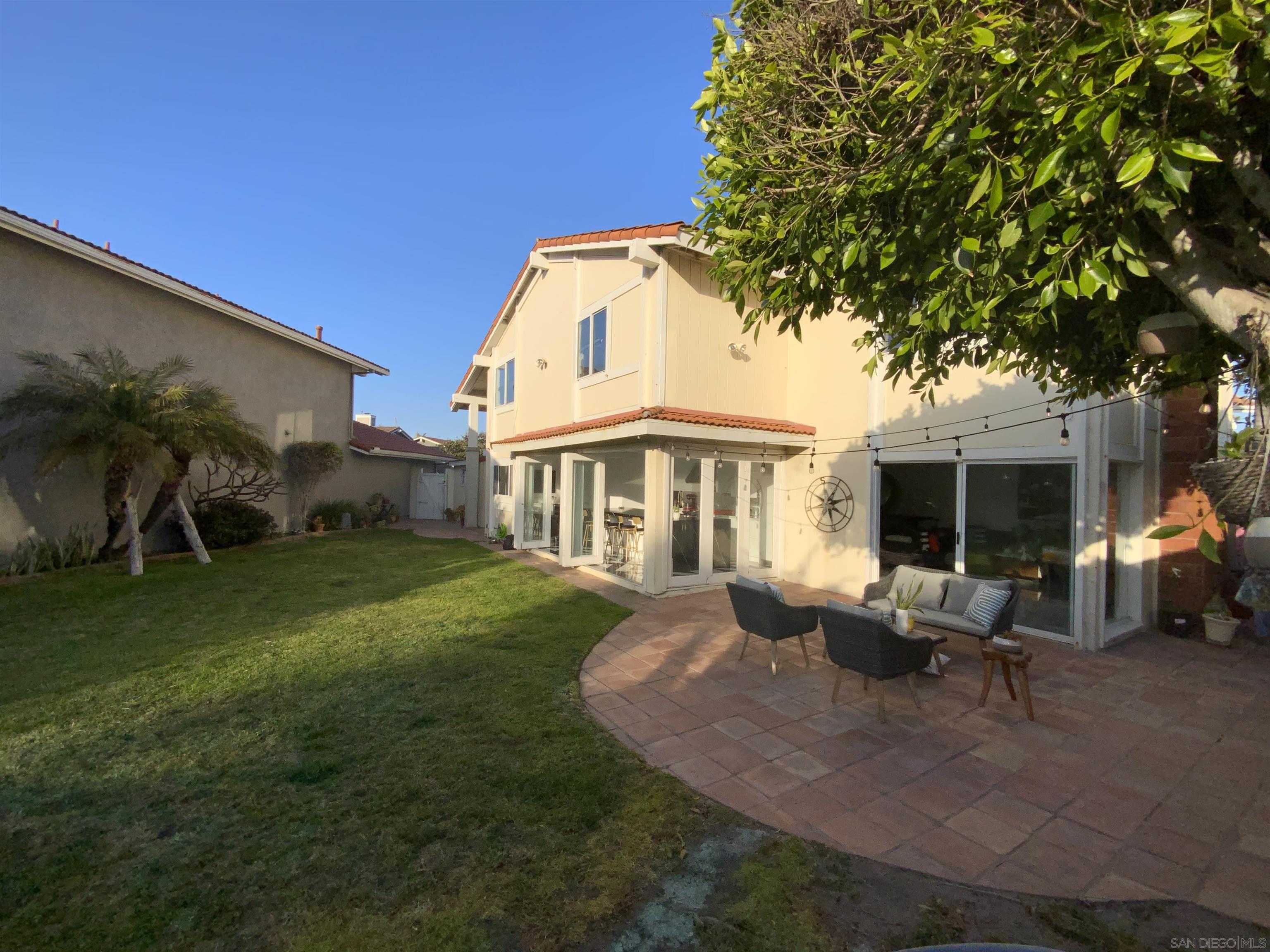 a view of a house with backyard porch and sitting area