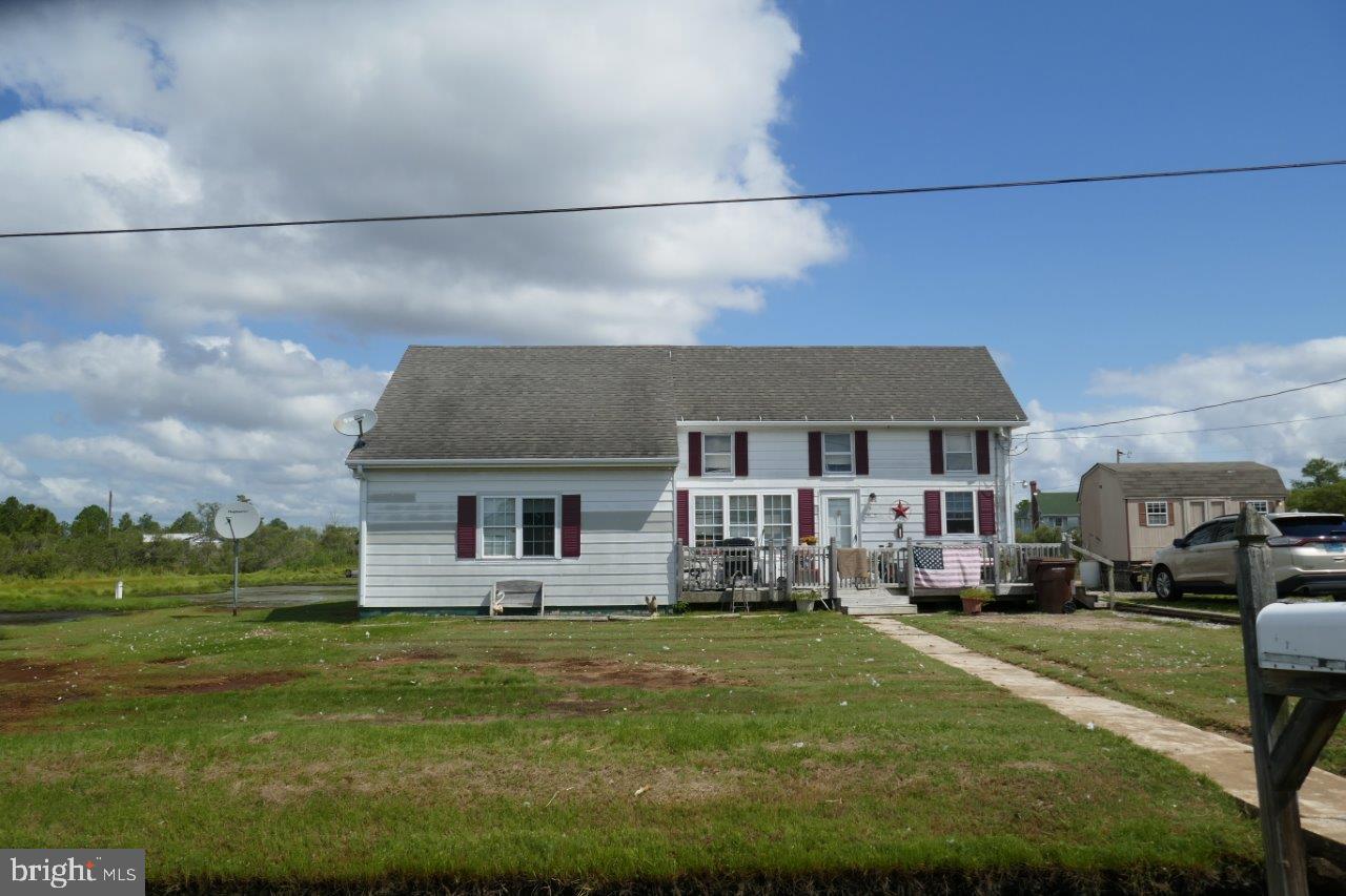 a front view of a house with a yard table and chairs