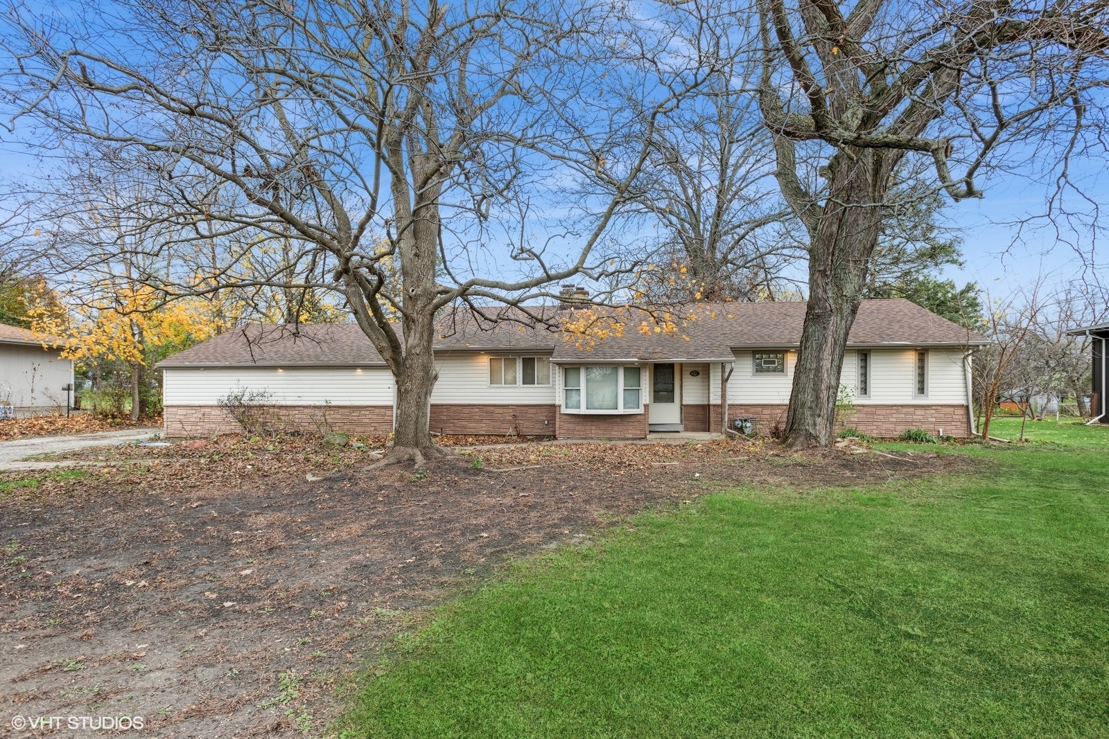 a view of house with backyard and a garden