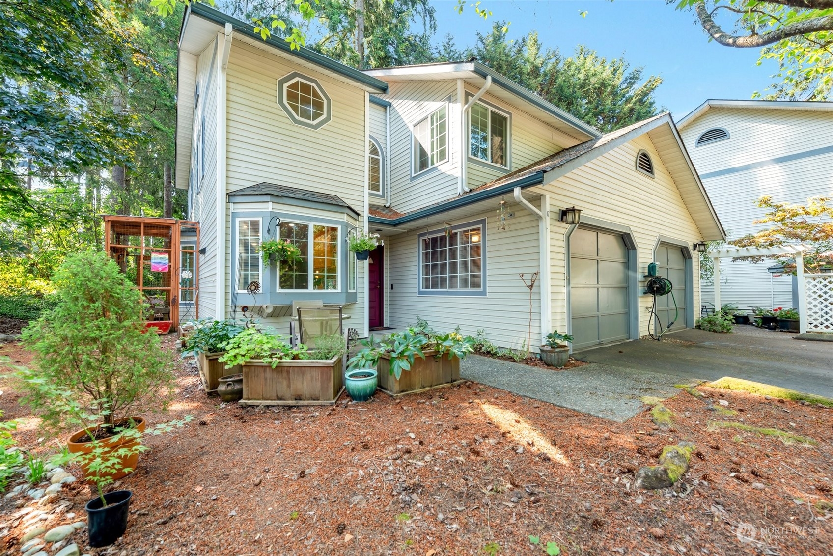 a view of a house with a yard and potted plants