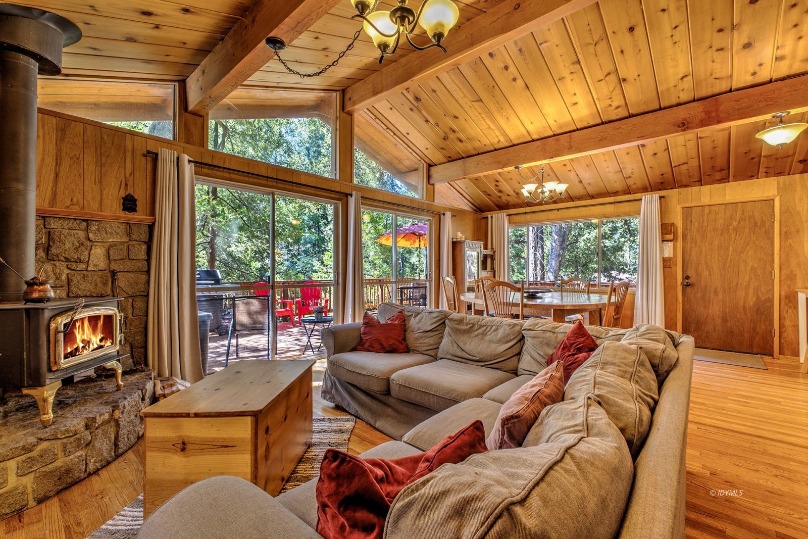 a living room with furniture a fireplace and large windows