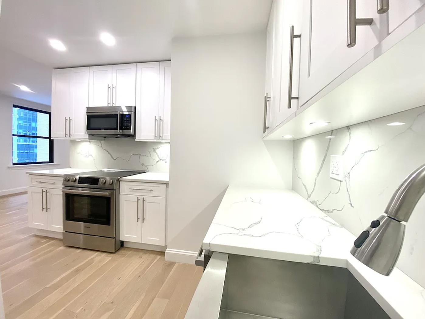 a kitchen with a sink and a stove top oven