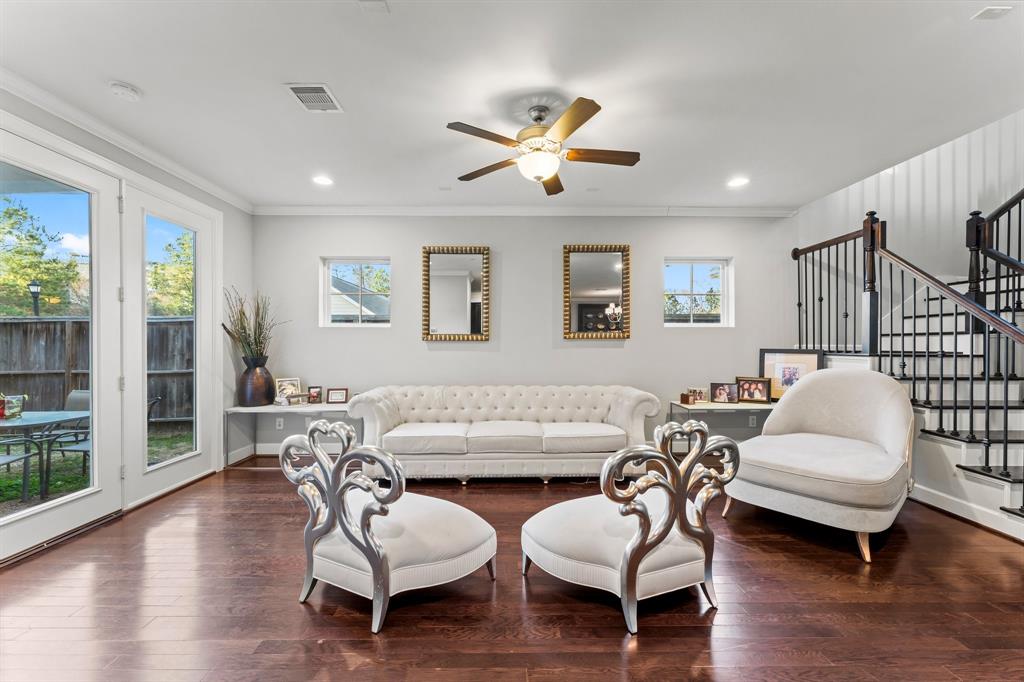 a living room with furniture and wooden floor