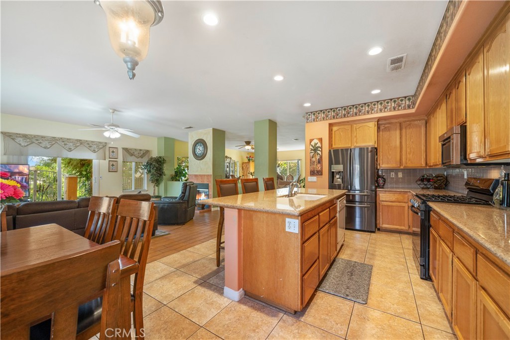 a large kitchen with a large counter top appliances and furniture