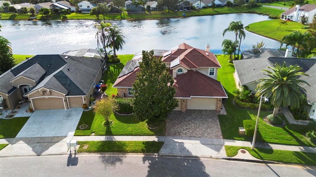 an aerial view of a house with a lake view