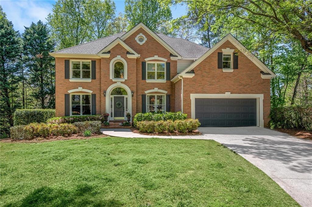 a front view of a house with a yard and garage