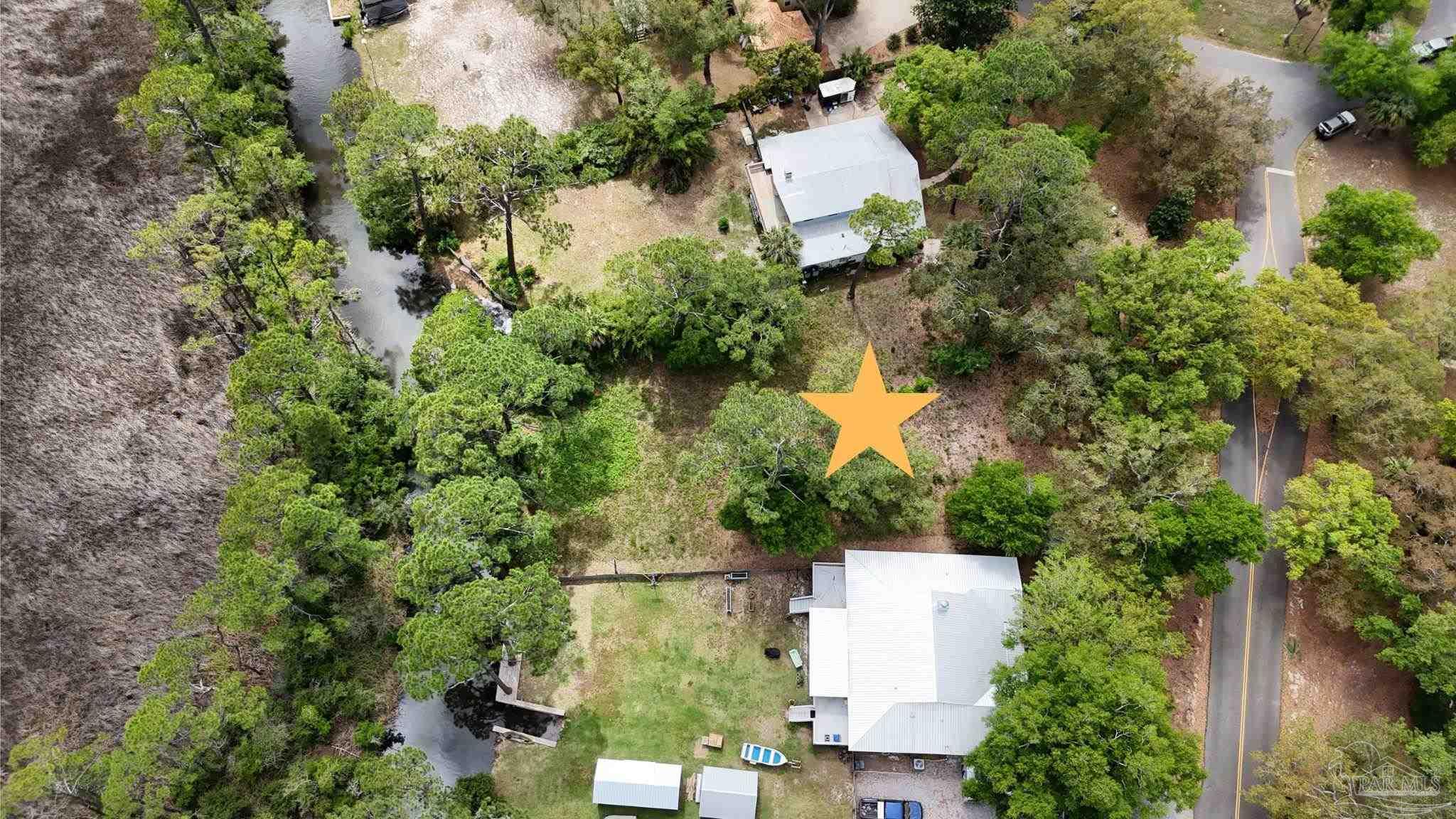 an aerial view of a house with a yard and garden