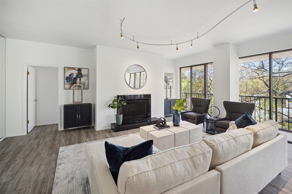 Living room with fireplace and sliding door to balcony.