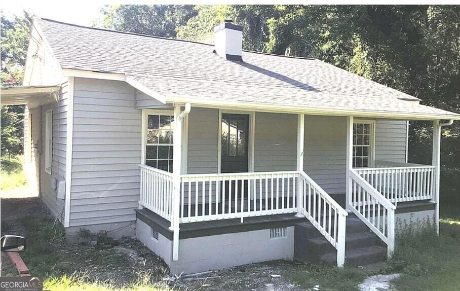 a view of a house with a yard and deck