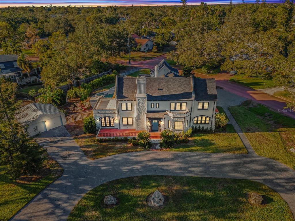 an aerial view of a house with a yard