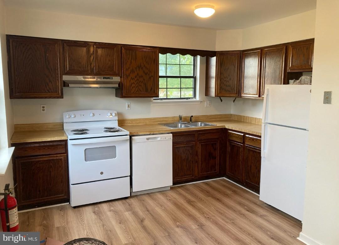 a kitchen with a stove a sink and a refrigerator