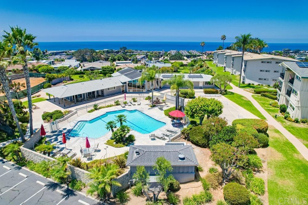 an aerial view of swimming pool patio and mountain view in back