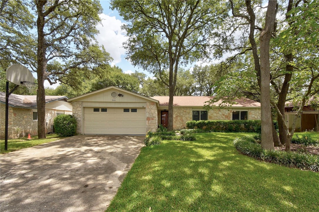 a front view of house with yard and green space