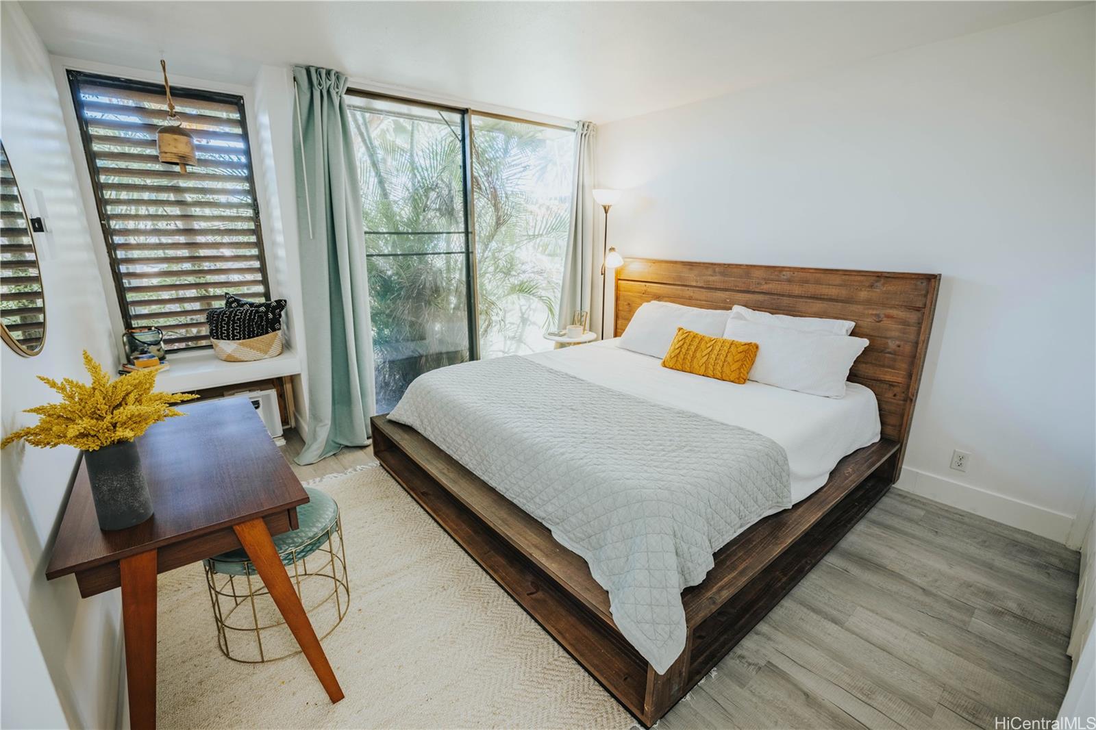 a bed sitting in a bedroom next to a window