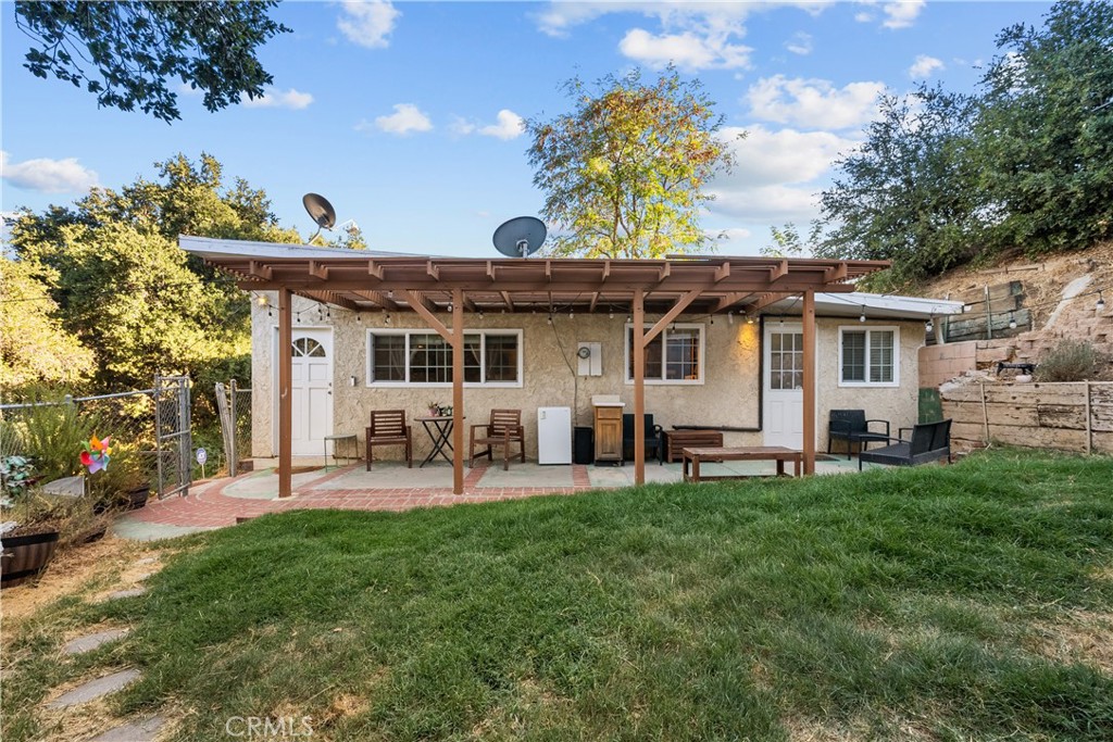 a view of a house with a yard and sitting area