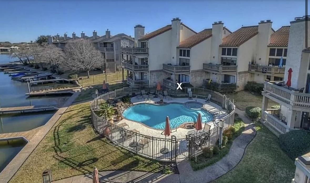 a swimming pool with outdoor seating and yard