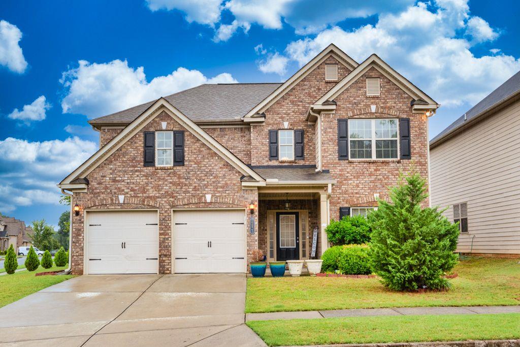 a front view of a house with a yard