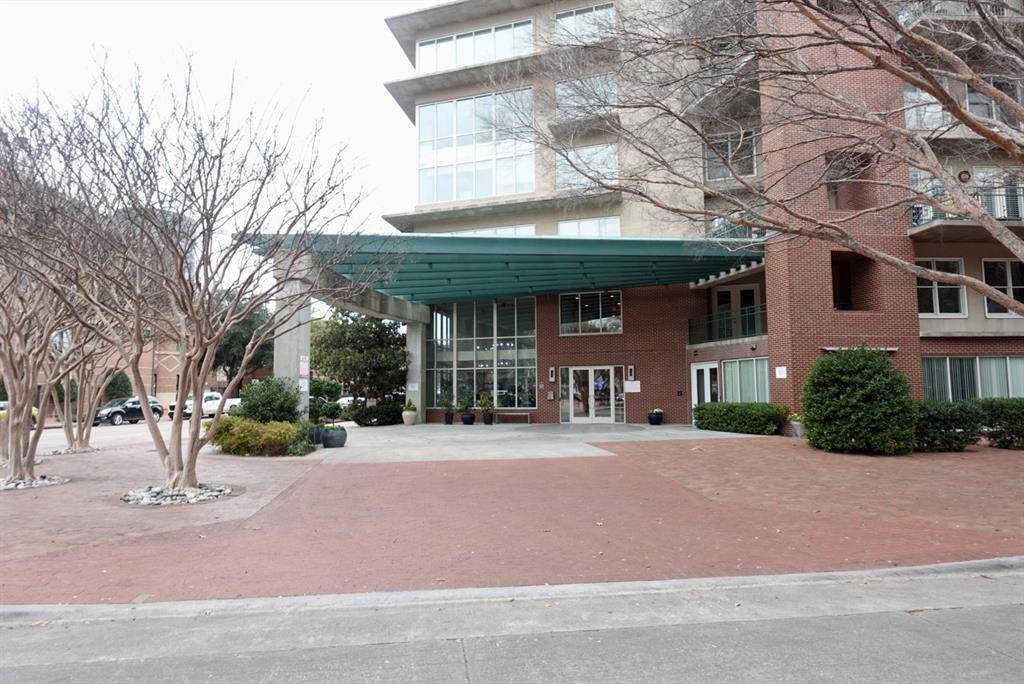 a front view of a building with a garden