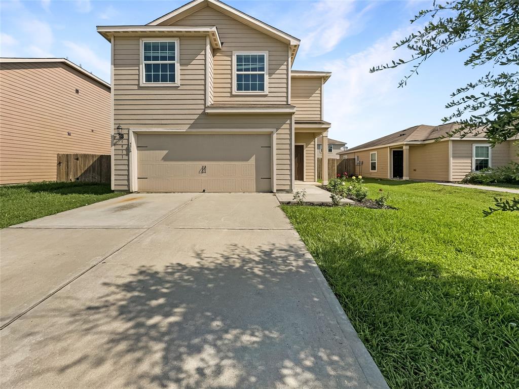 a front view of a house with a yard and garage