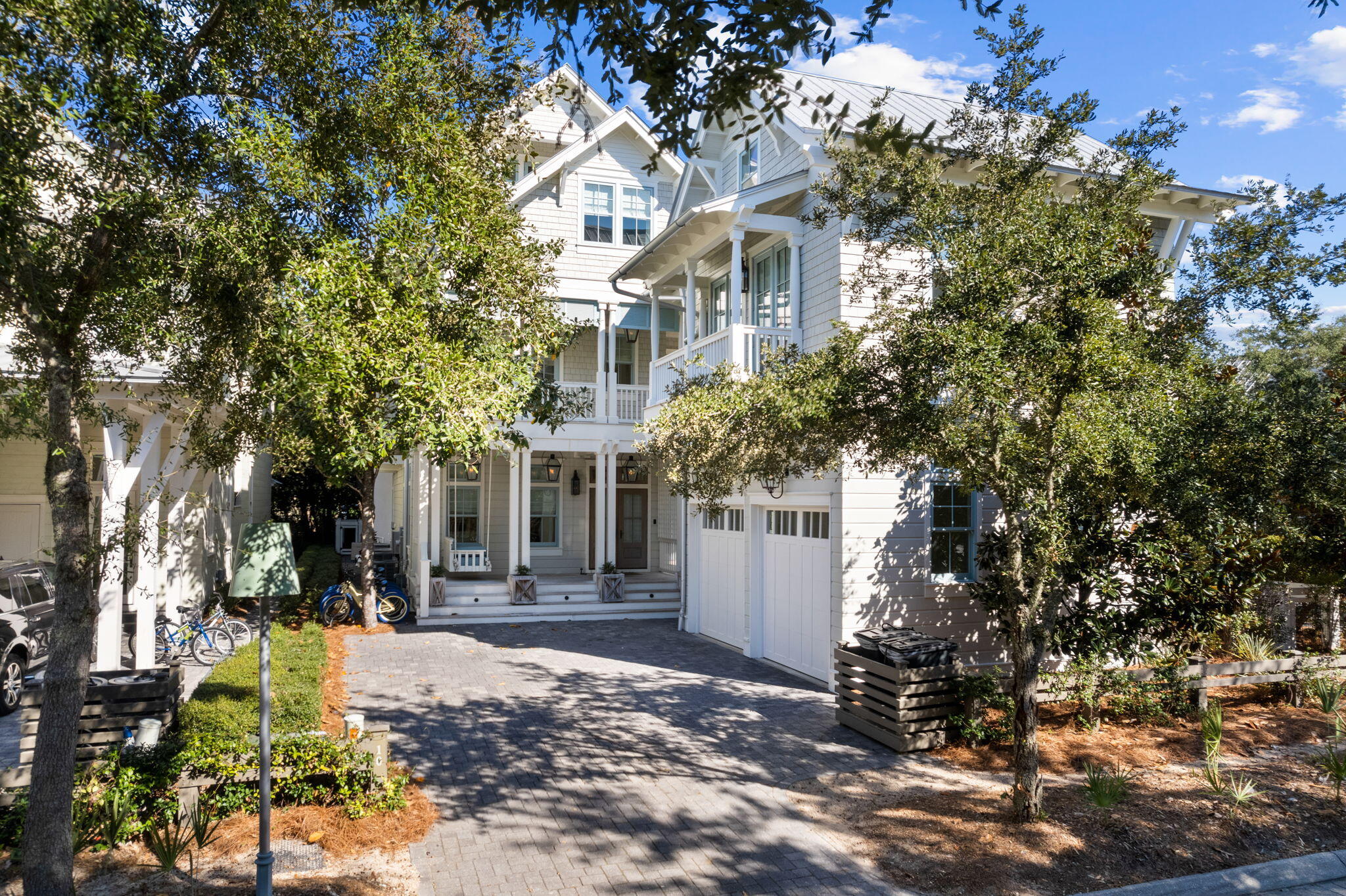 a front view of a house with a tree