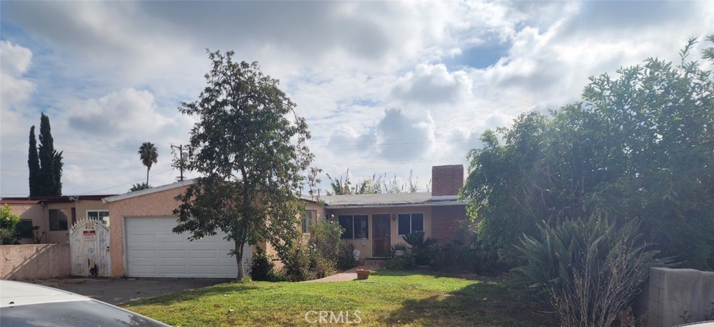 a view of house with yard and entertaining space