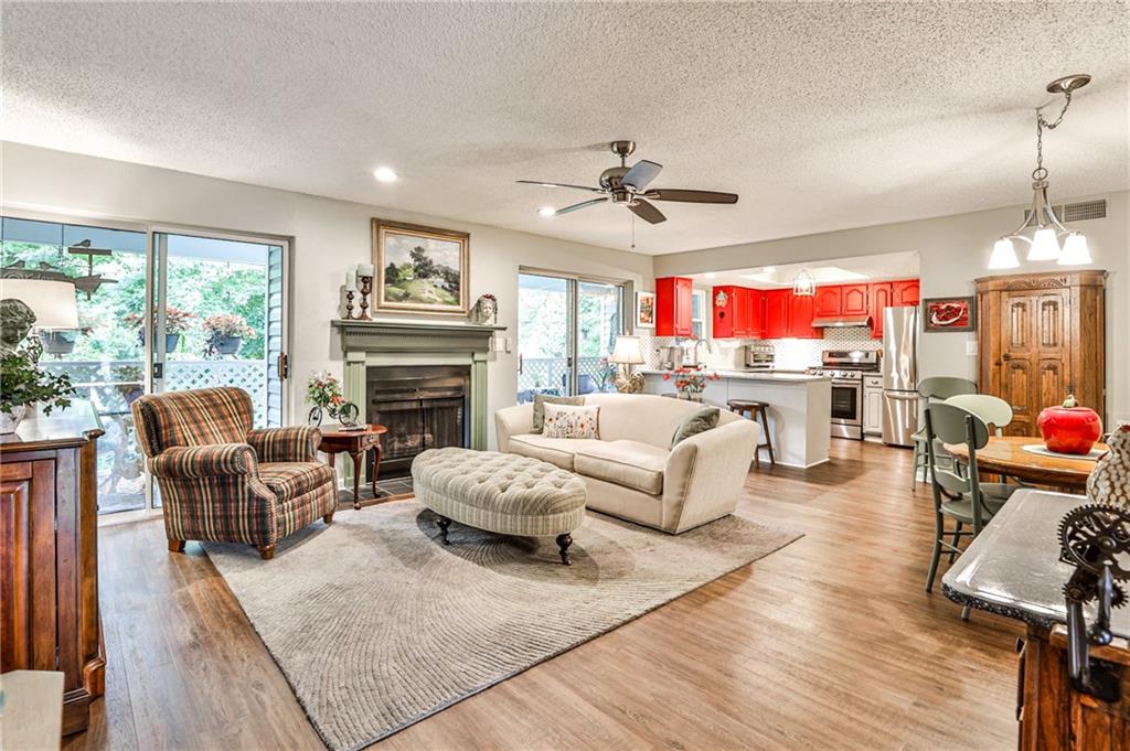 a living room with furniture fireplace and a large window