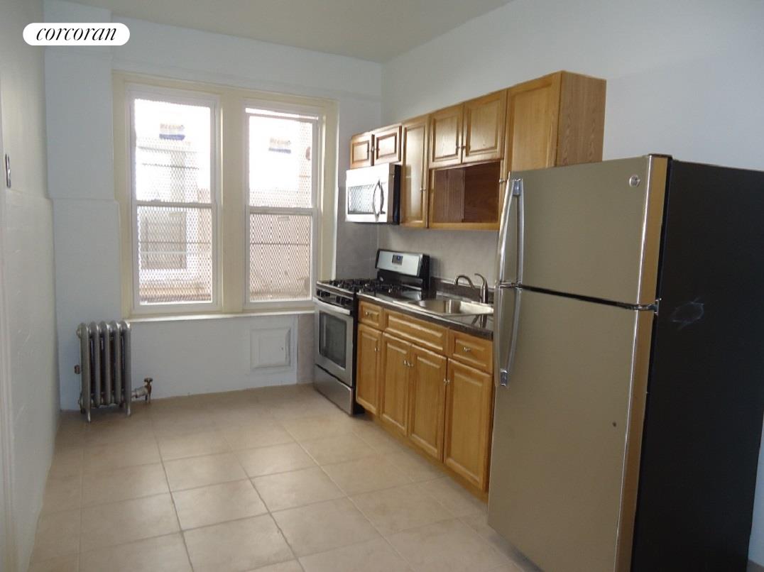 a kitchen with stainless steel appliances a refrigerator sink and cabinets